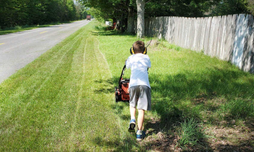 8 Year old Takes on The 50 Yard Challenge Mows Lawns for Veterans